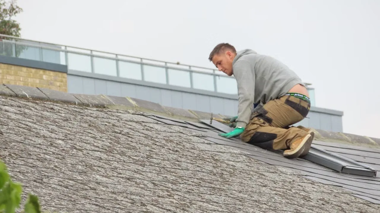 Roofer installing architectural shingles on a roof