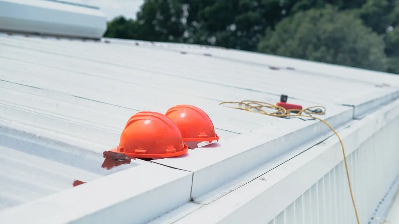 Orange construction helmets on a rooftop
