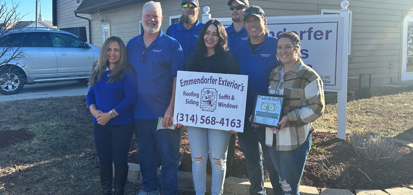 The Emmendorfer family and crew outside their Union, Missouri office, holding the company sign